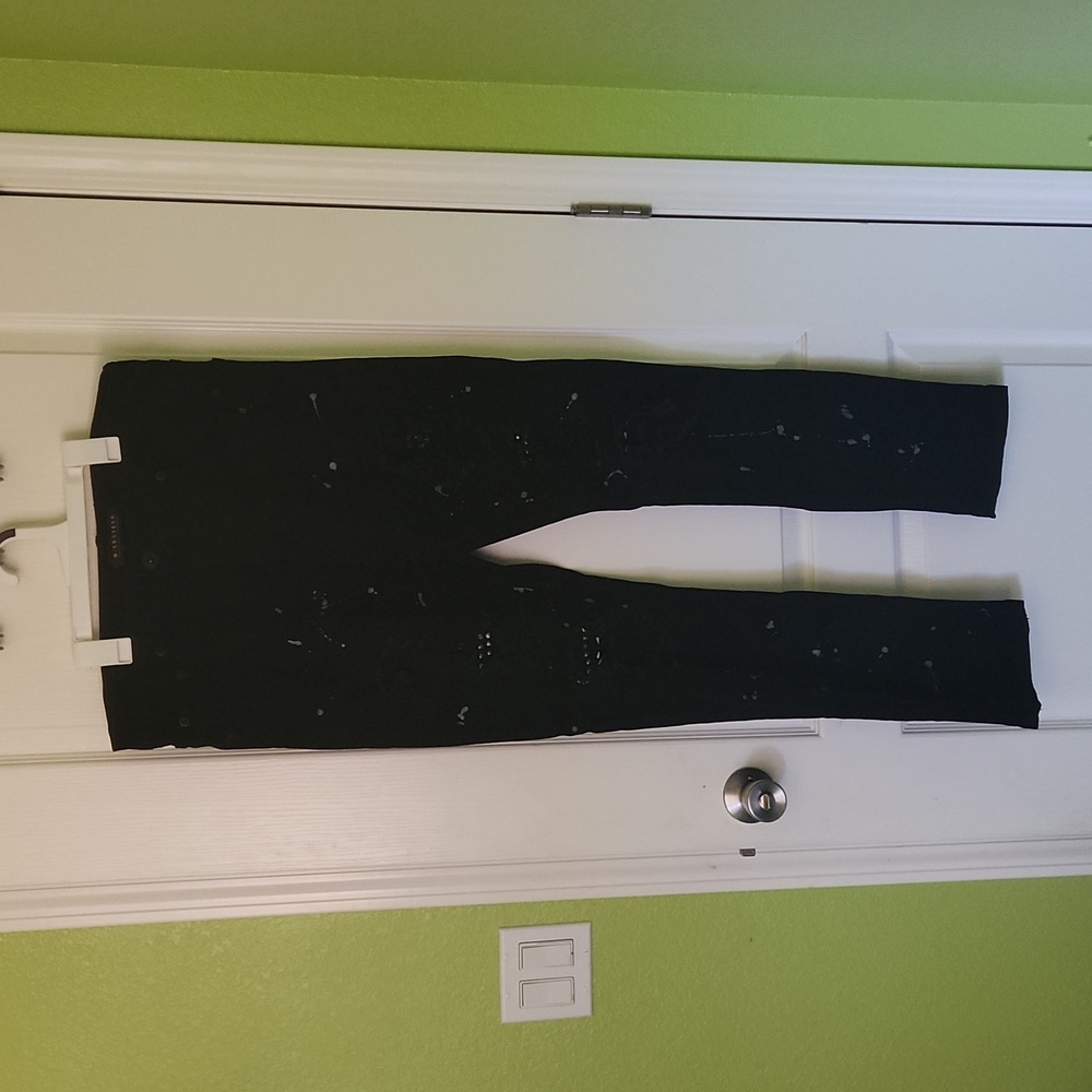 Black jeans with studs and paint splatter